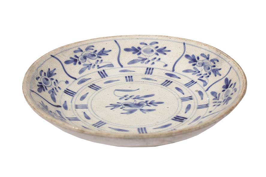 A blue and white dish with flower decoration