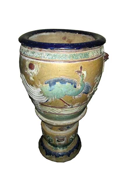 A Chinese stoneware pot and stand with motif colour decoration