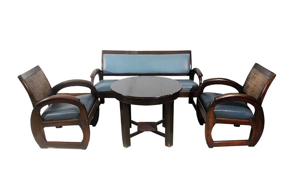 A set of wooden furniture consisting of three-seater sofa, two arm chairs and wooden round table