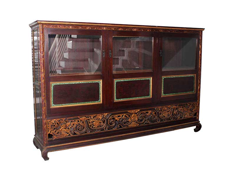 A three-door display cabinet with decoration ornaments