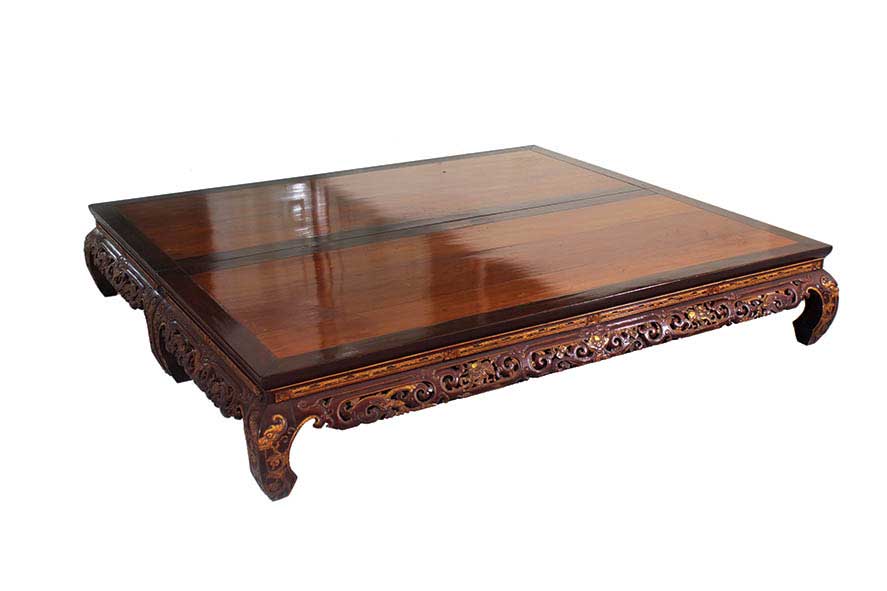 A pair of Chinese brown gilt wooden low tables with carving