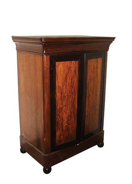 A wooden cabinet with two panelled doors