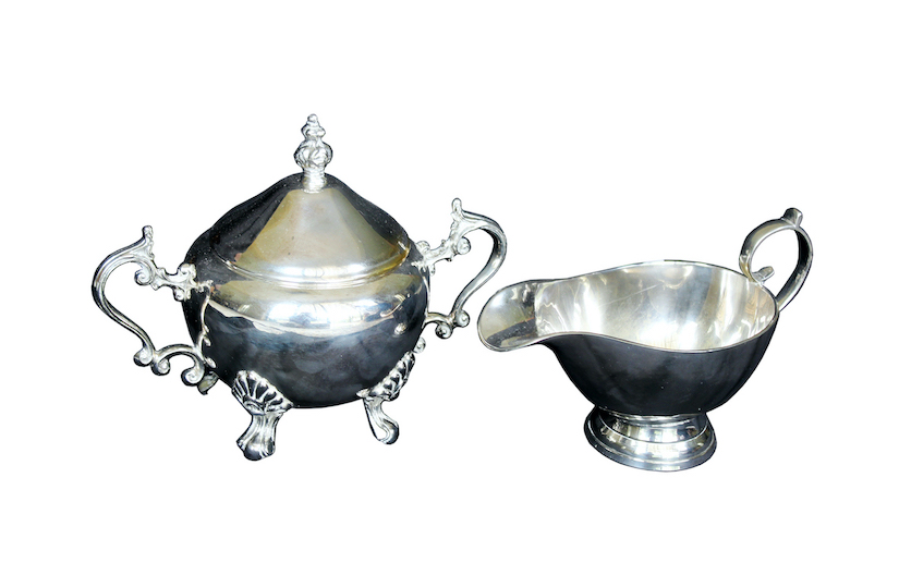 A silver plated sugar bowl with lid and a sauce boat