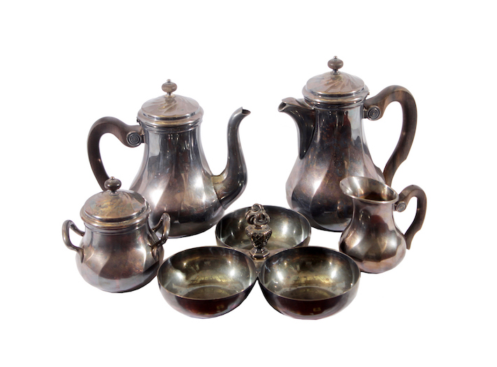A silverplated tea set consisting of a tea pot, a sugar pot, two additional containers without lids
