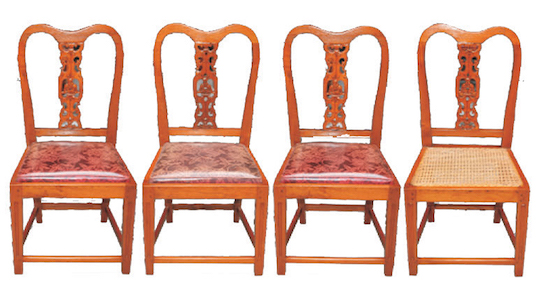 A set of four wooden dining chairs