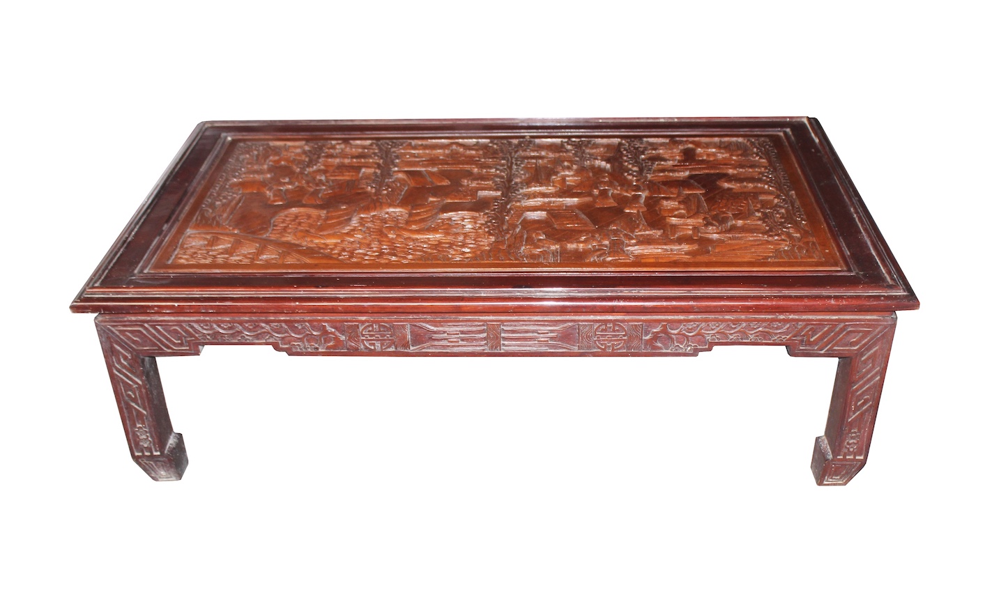 A Chinese coffee table with carved top, and carved apron on four sides on straight legs