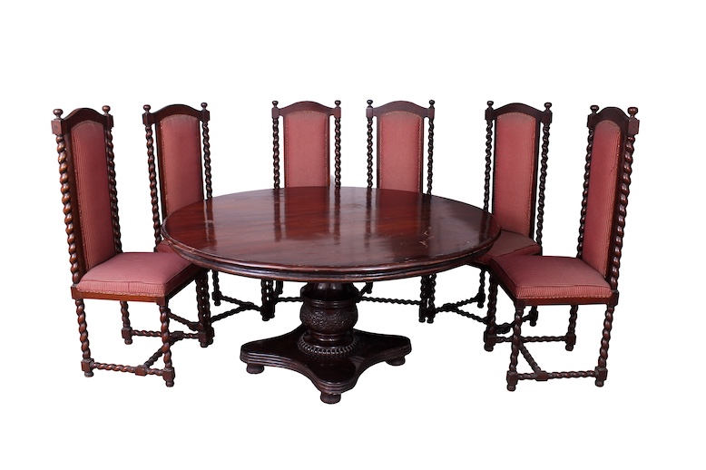 A set of seven of 20th century carved teak dining furniture, consisting of a round table and six red upholstered chairs