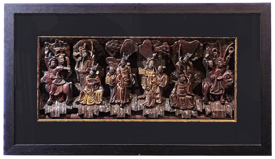 A 19th century Chinese carved gilt wood wall panel with twelve figures and two animals in glass frame
