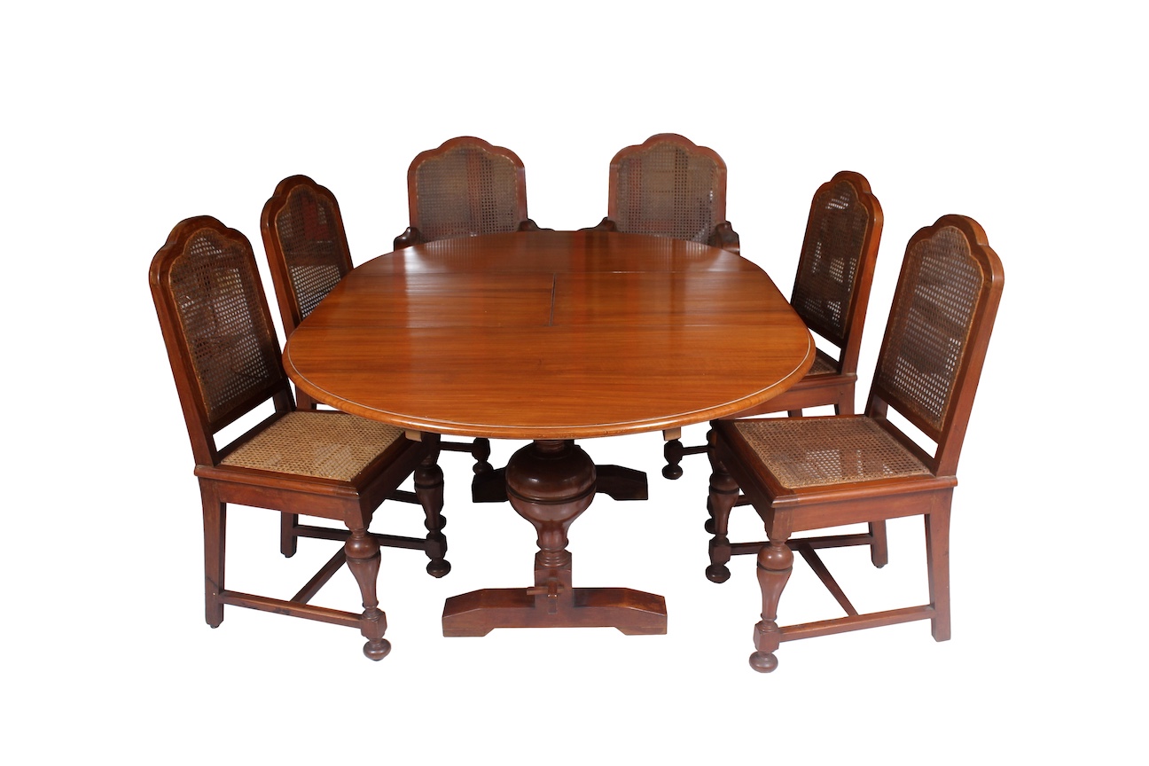 A set of dining room furniture, consisting of a wooden extendable teak table, two rattan seat armchairs and four rattan seat chairs