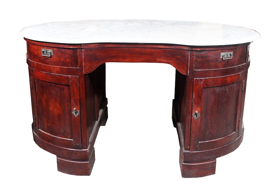 A first half 20th century Dutch colonial period carved kidney form writing table with marble top