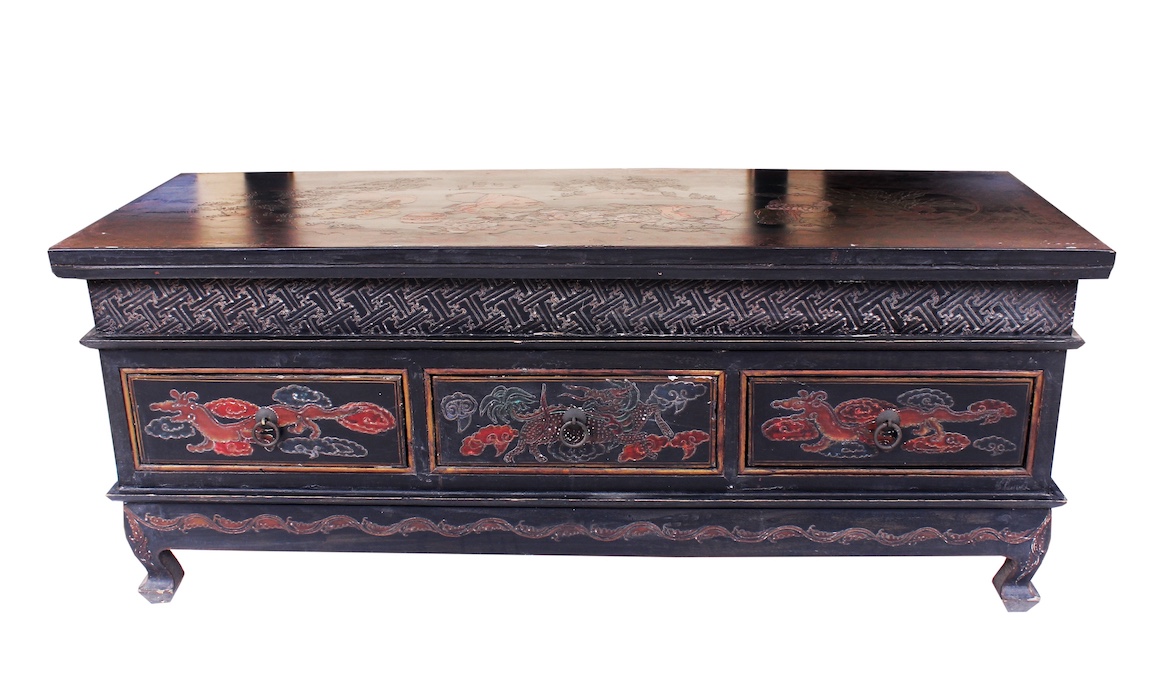 A carved teak sideboard with three drawers