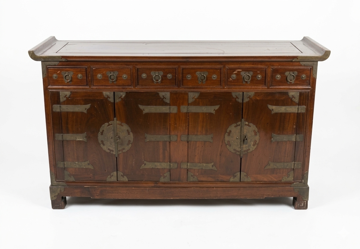 A Korean wooden sideboard with drawers and brass mounts