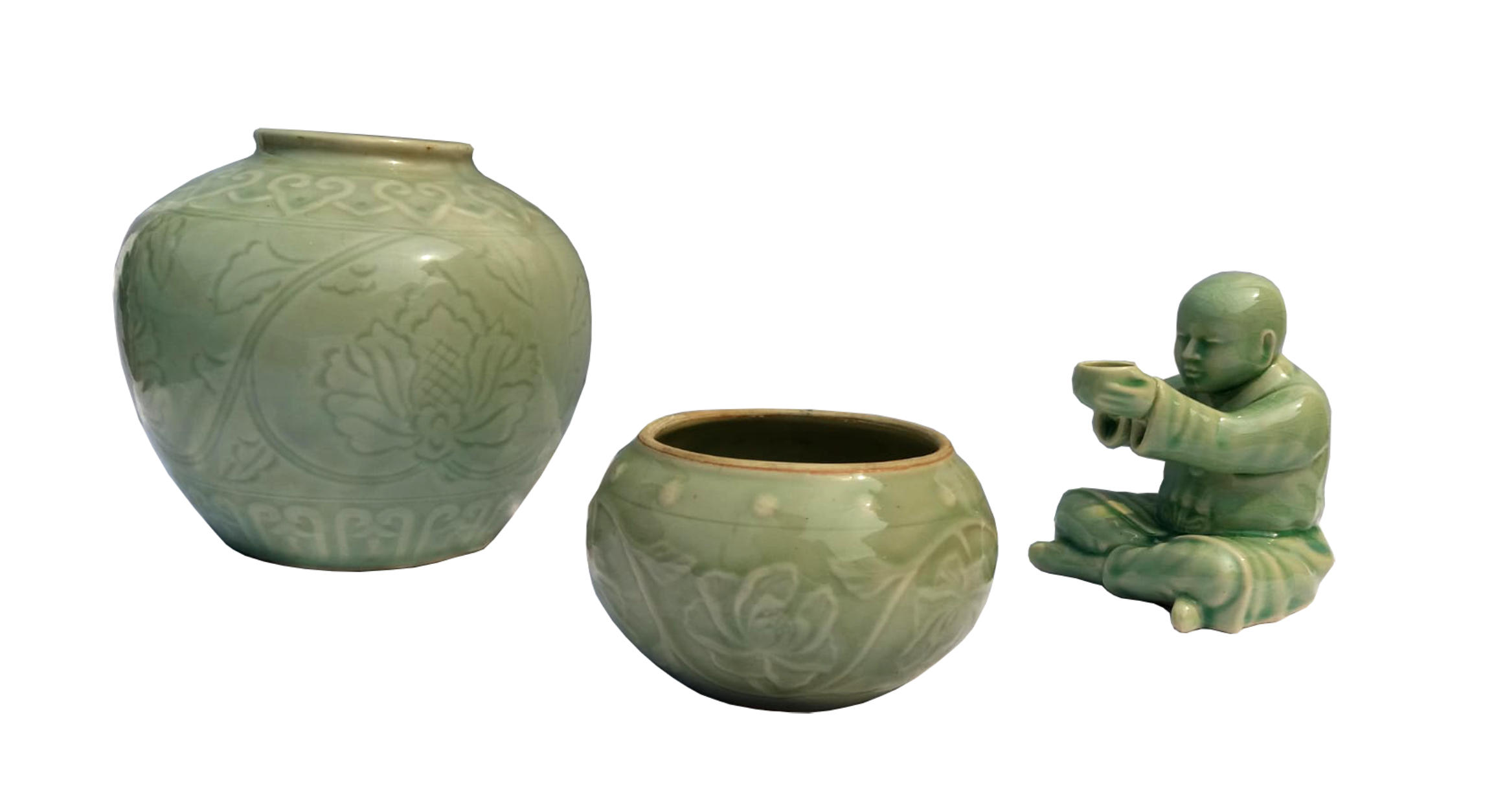 A 20th century set of three modern chinese celadon ware consisting of two pieces of jars with flower scroll and a figurine of sitting monk