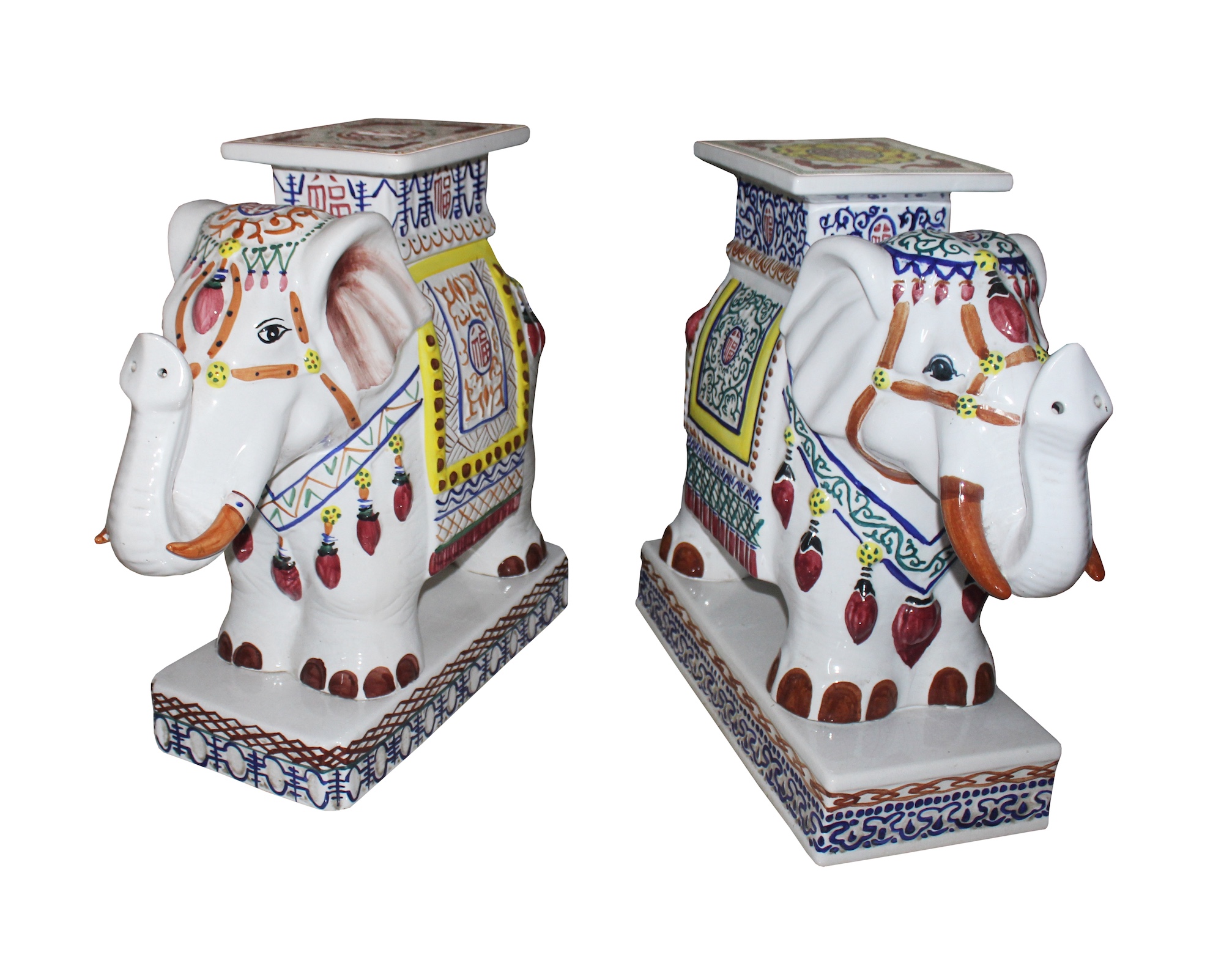 A pair of modern polychrome ceramic stands model of standing elephants