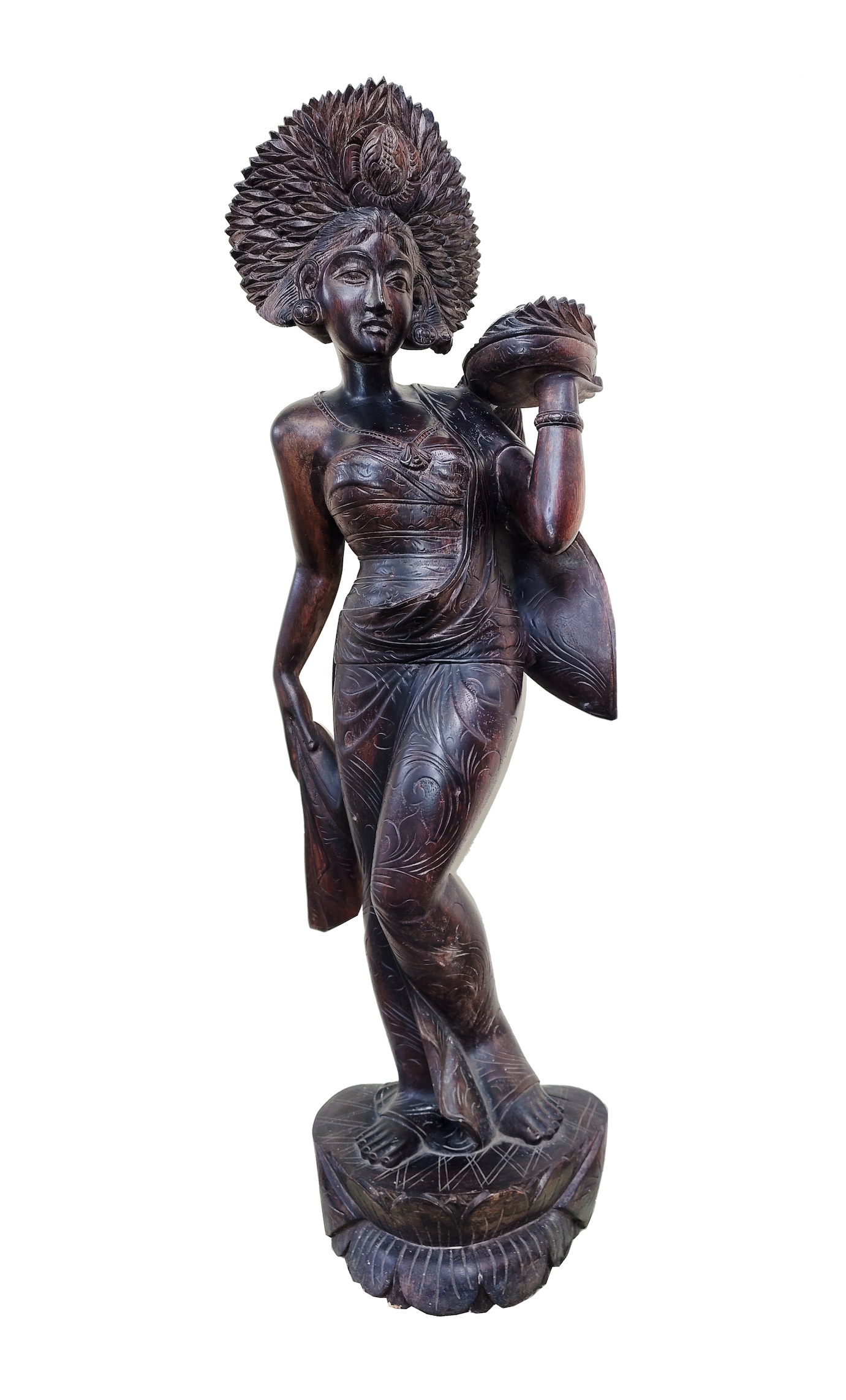 A carved wood figure of standing Balinese dancer