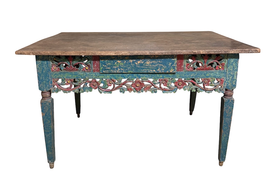 A 20th century carved and painted teak table with drawer