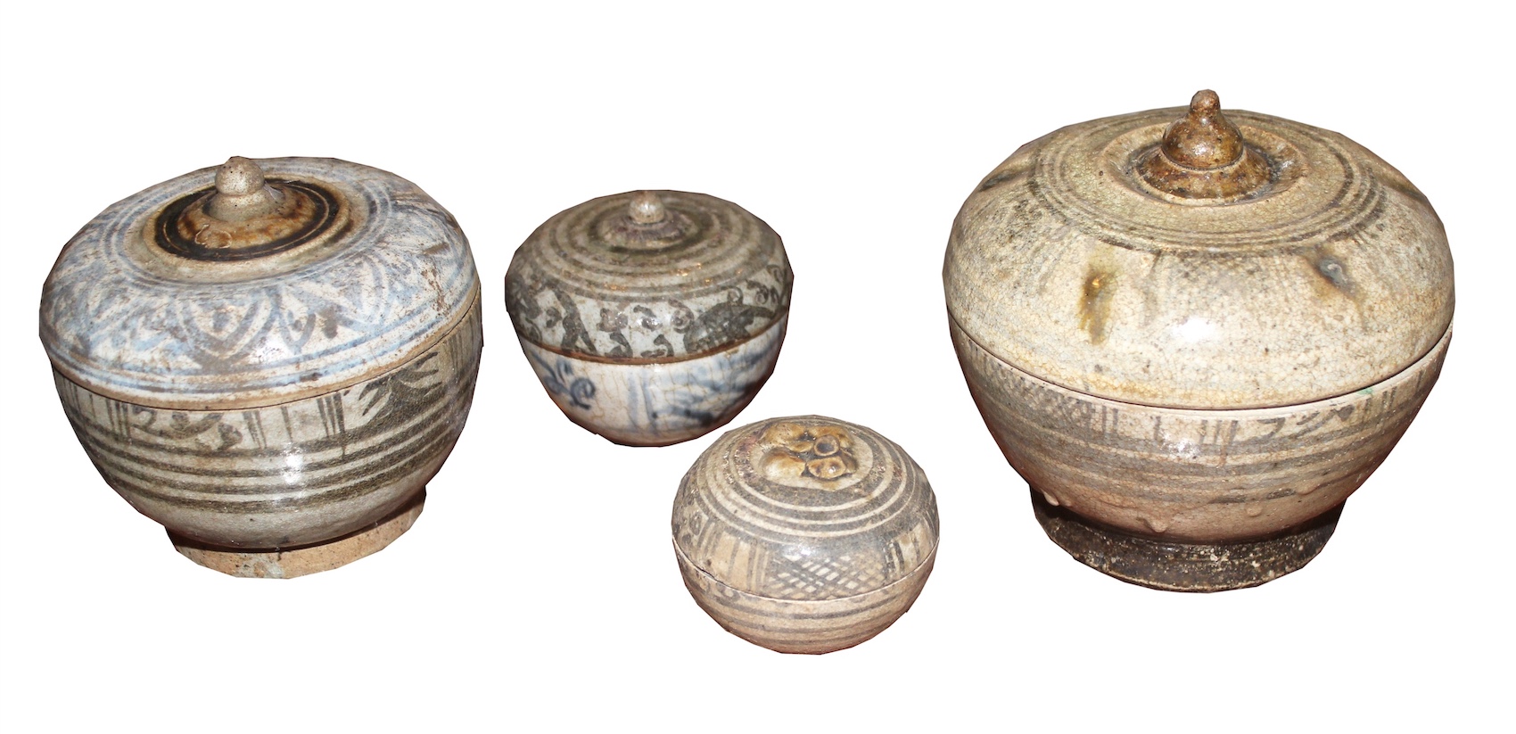 A 14th - 16th century group of four Sawankhalok covered bowls