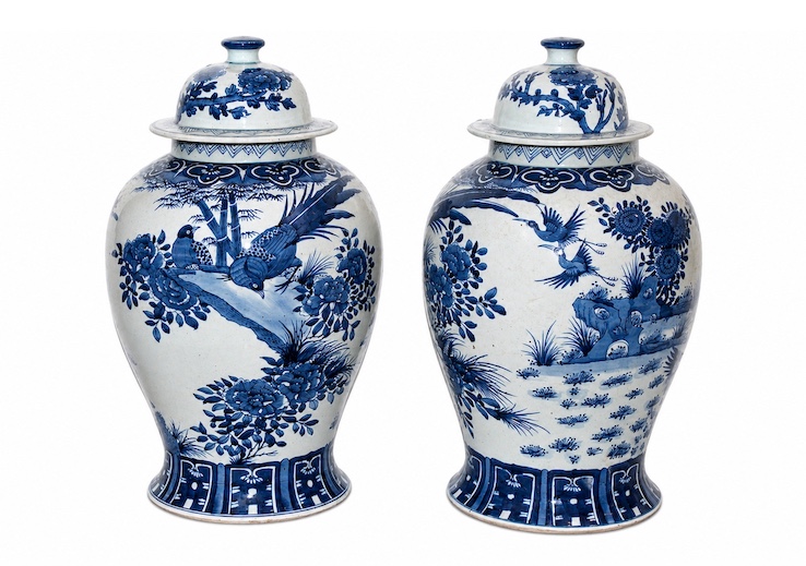 A pair of 20th century modern blue and white covered jars hand painted with flowers and birds